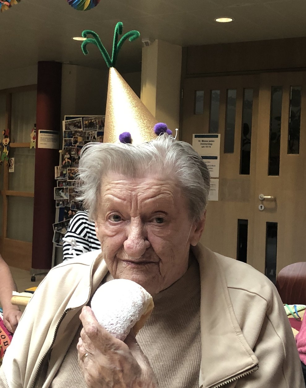 Eine Dame isst einen Krapfen. 