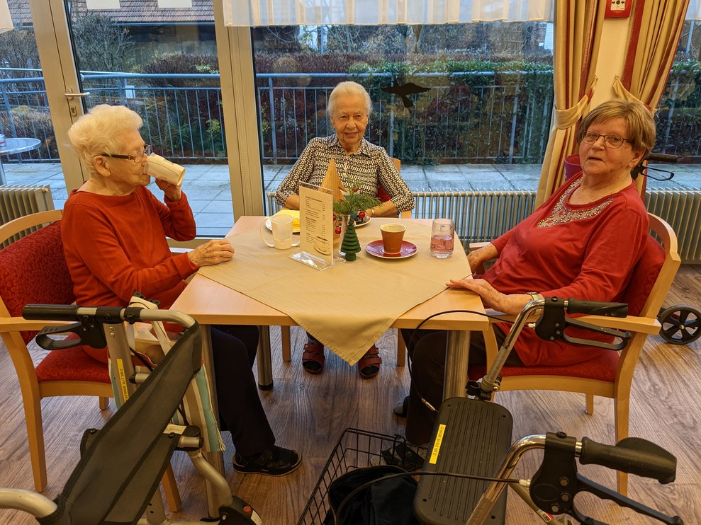 Drei Damen bei Tisch.