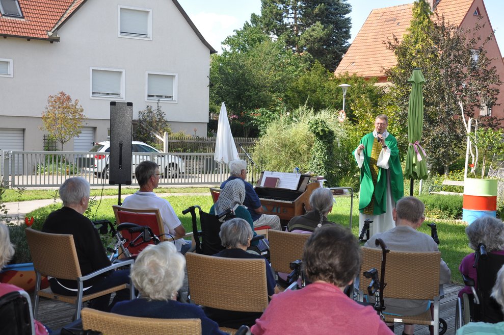 BewohnerInnen sitzen draußen.