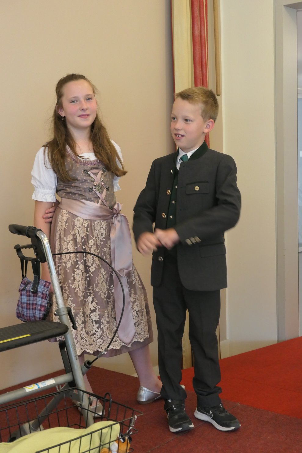 Ein Bub m Trachtenanzug und ein Mädchen im Dirndl auf dem Laufsteg.