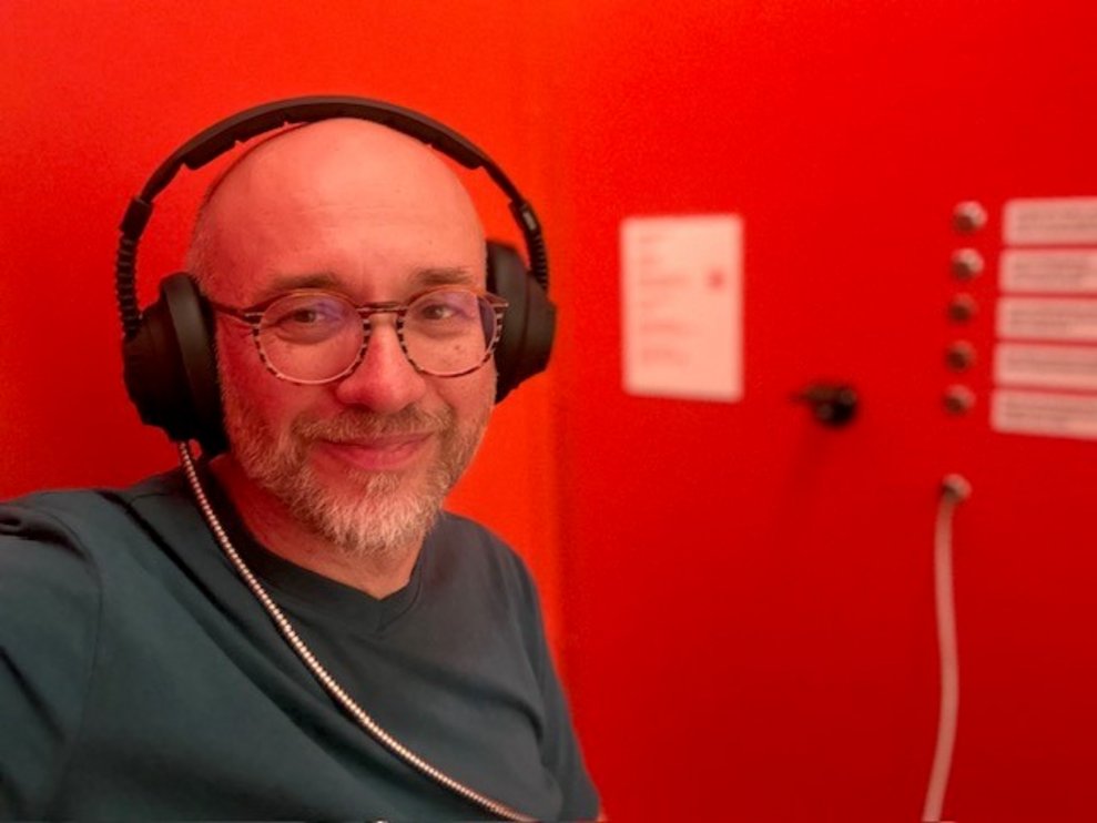 ein Mann mit Kopfhörer in einer roten Kabine