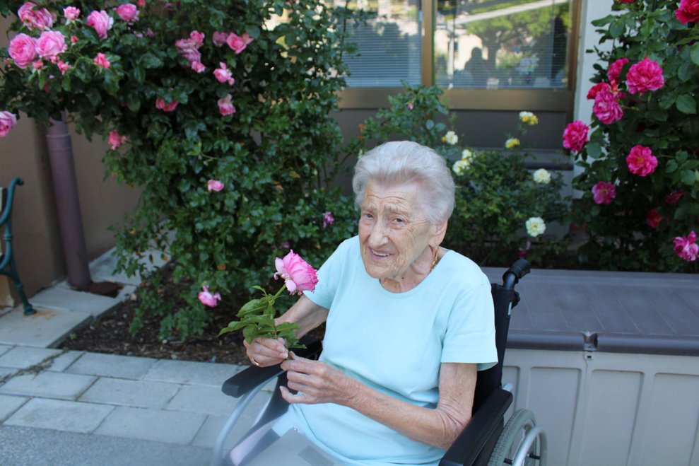 Bewohnerin schneidet sich Rose ab