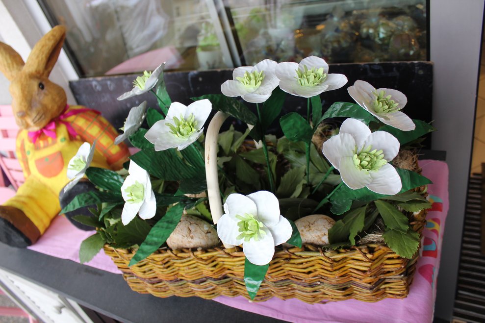 Weiße Blumen aus bemalten Bleichteilen in einem Korb