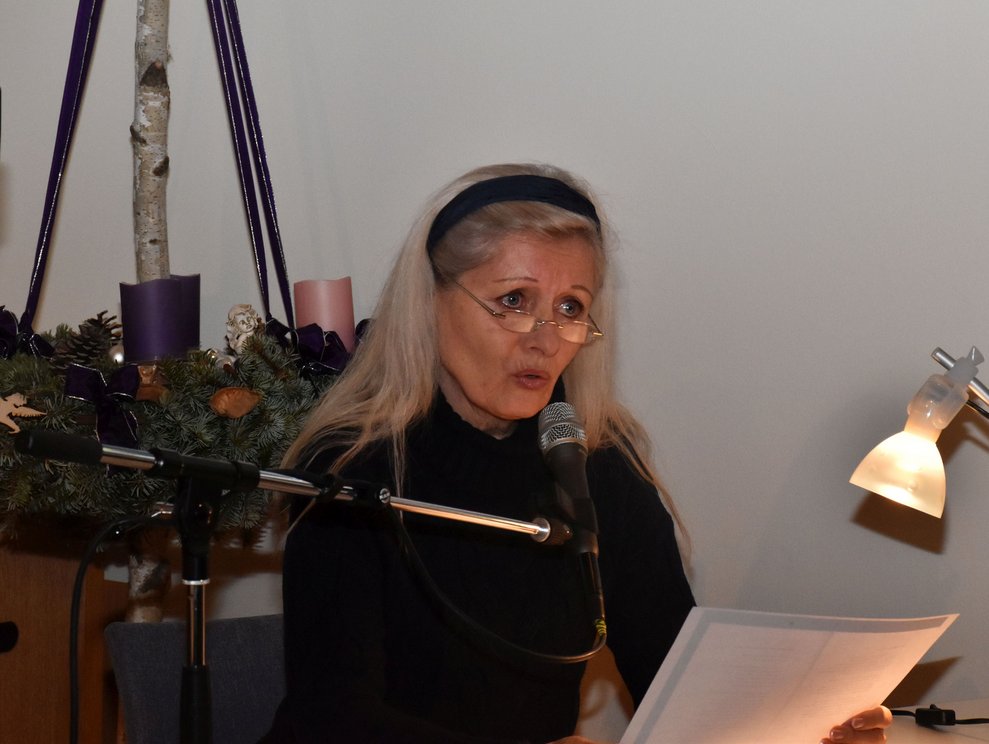 Margit Biedermann liest aus einem Buch vor.