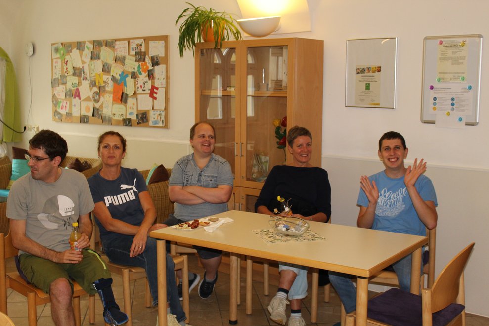 Fünf Personen sitzen bei einem Tisch