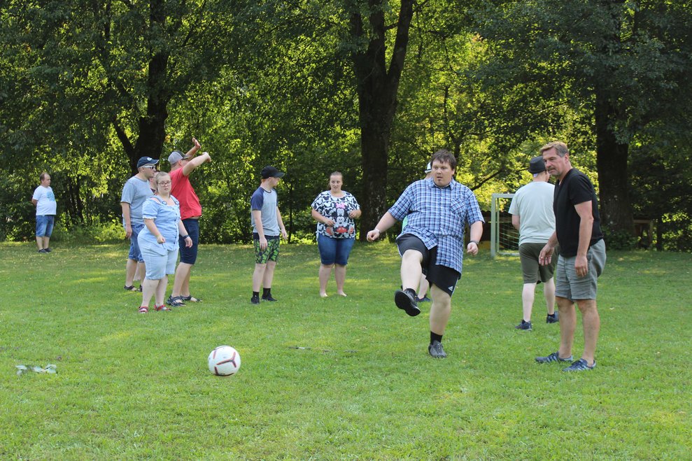 Eine Person schießt einen Ball in Richtung Fußballtor.