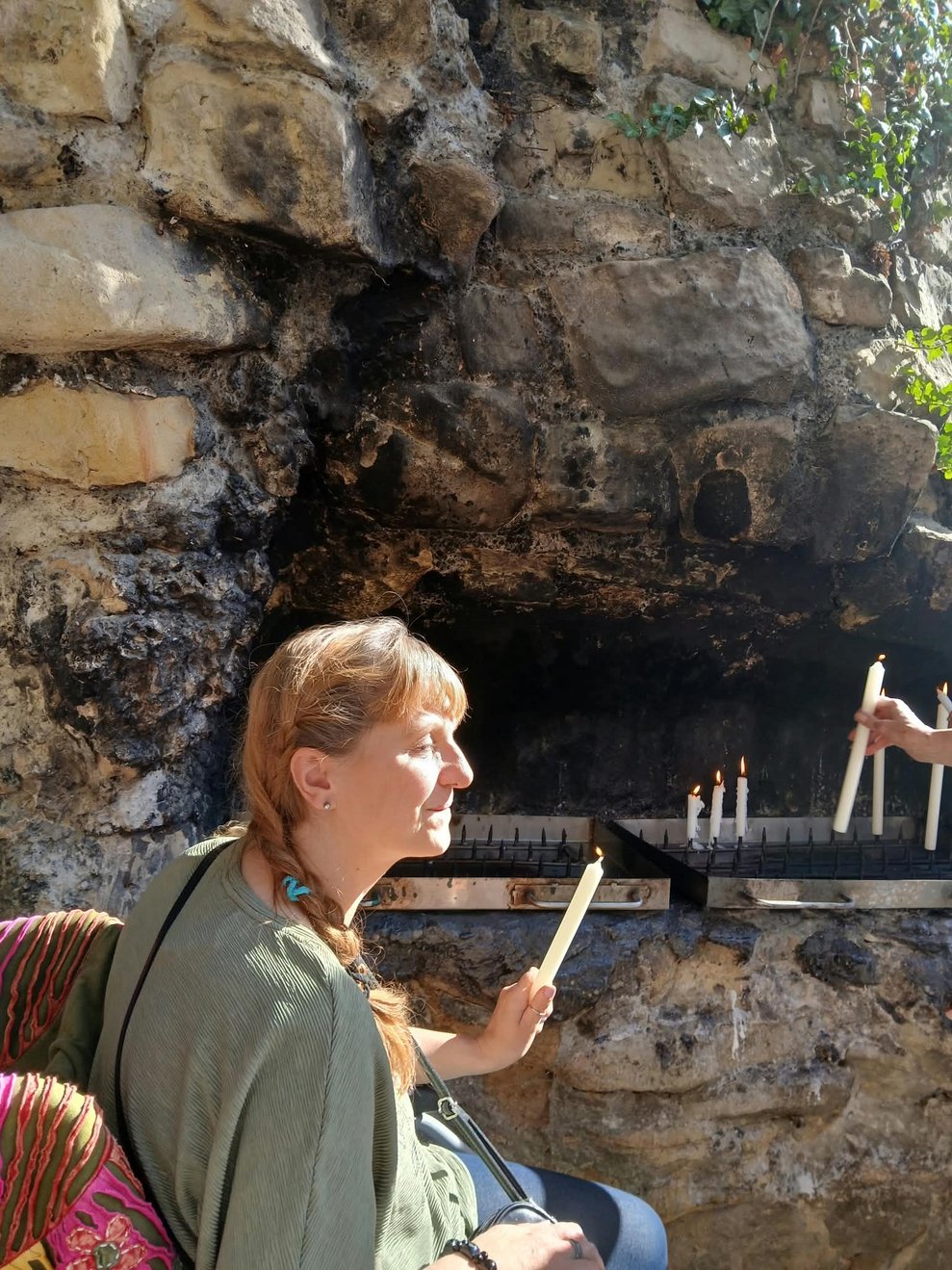Frau zündet Kerze an