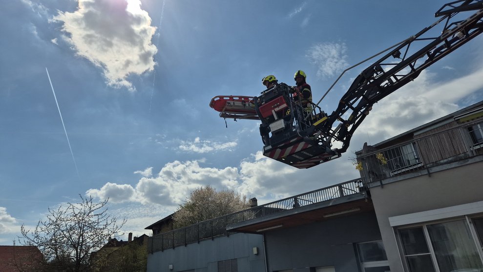 Drehleiter mit zwei Feuerwehrleute.