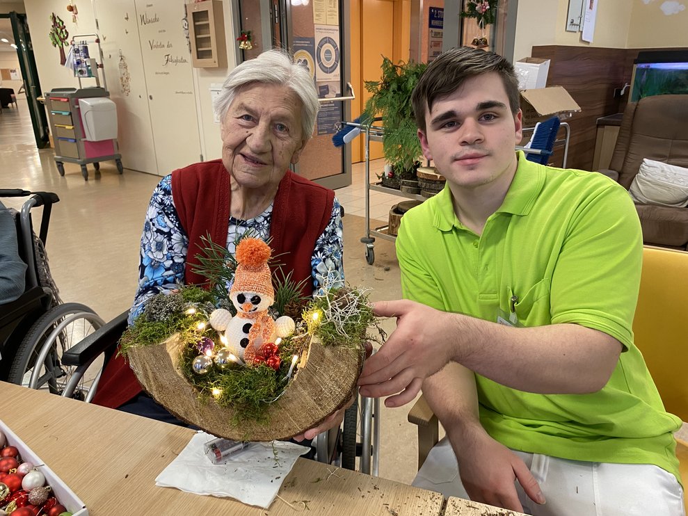 Zivi Rafael bastelt mit Frau Schindl.