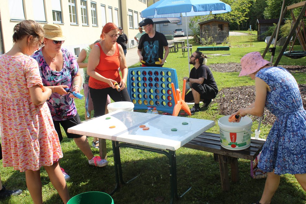 Mehrere Personen spielen zusammen Outdoorspiele.