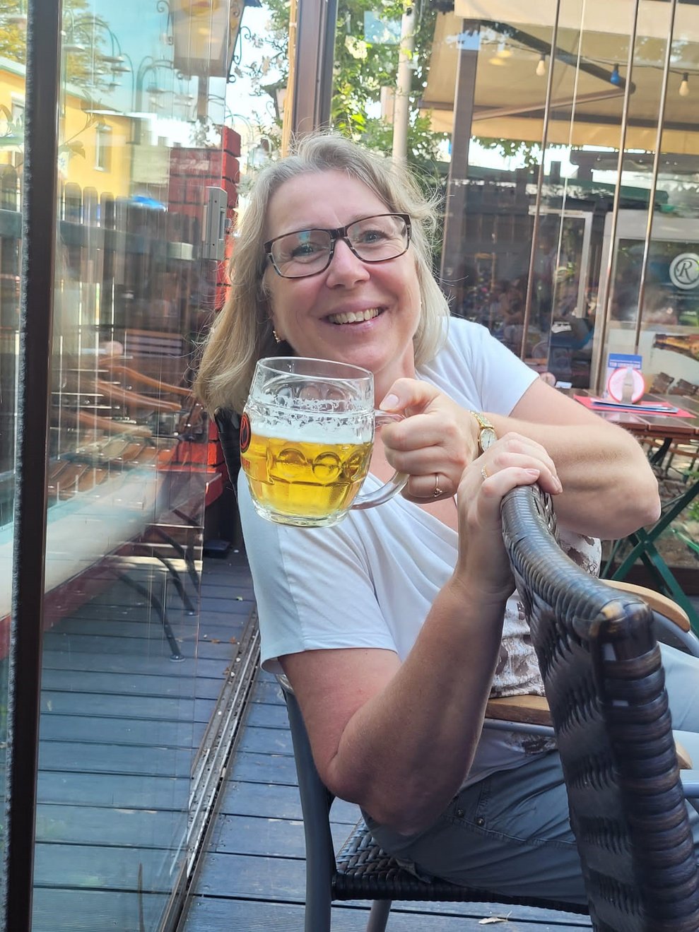 Eine Dame mit Bier in der Hand.